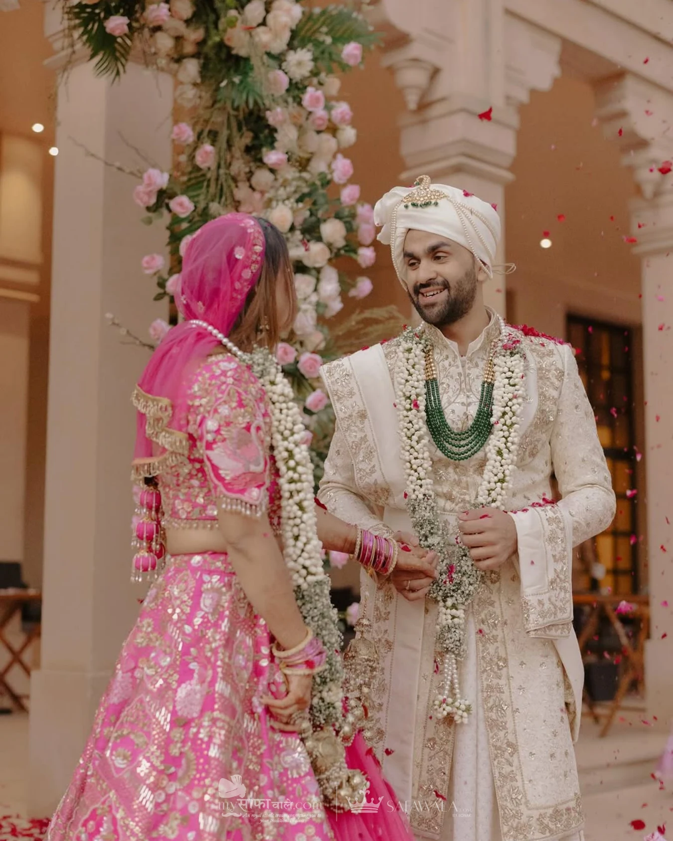 groom pagdi styling in Sharma Ji's Safawala – Close detail of a red wedding safa with an emerald kalgi